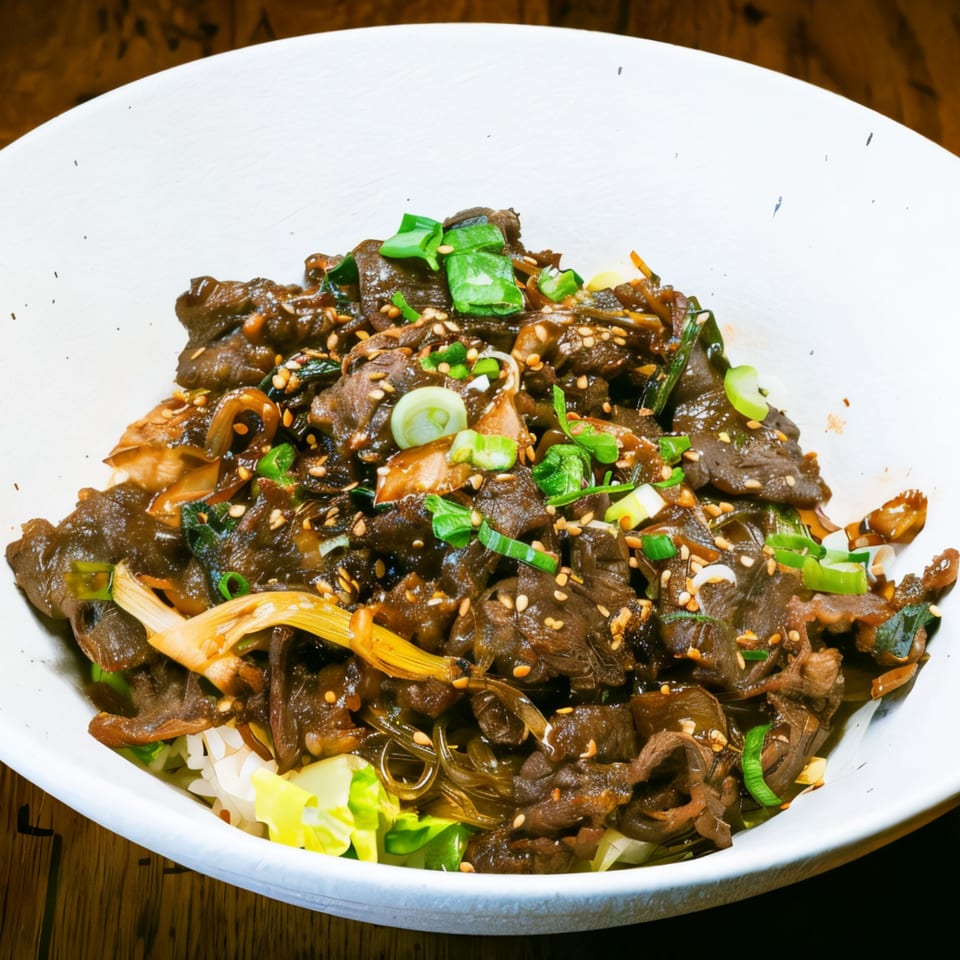 A close-up of Rock Pepper Fire's Korean beef bulgogi with rice, green onions, and sesame seeds.
