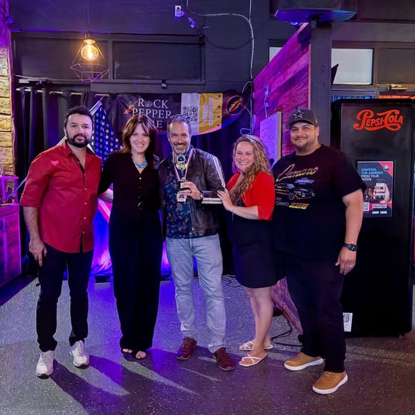 Five people, three men and two women, pose with a trophy at Rock Pepper Fire restaurant.